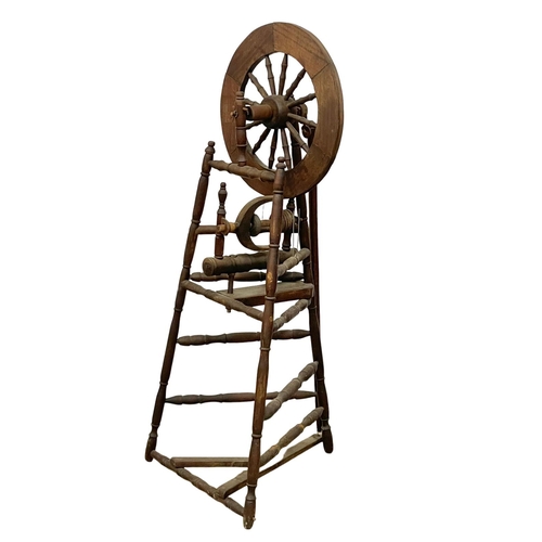 178 - A tall spinning wheel. 127cm