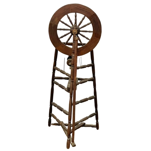 178 - A tall spinning wheel. 127cm