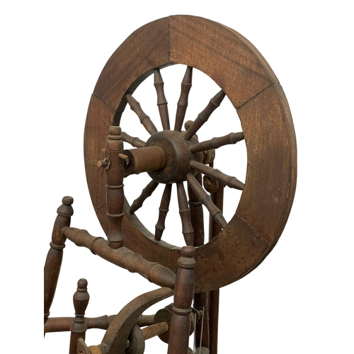 178 - A tall spinning wheel. 127cm