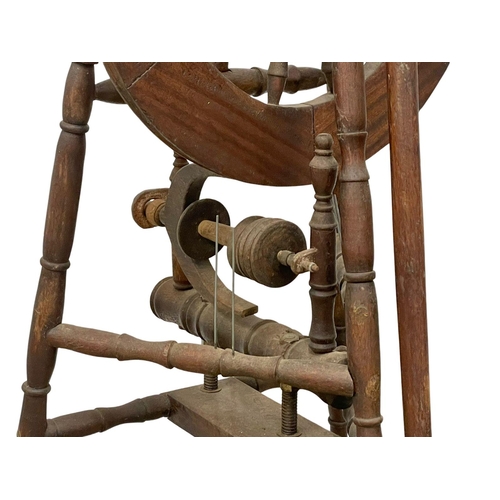 178 - A tall spinning wheel. 127cm