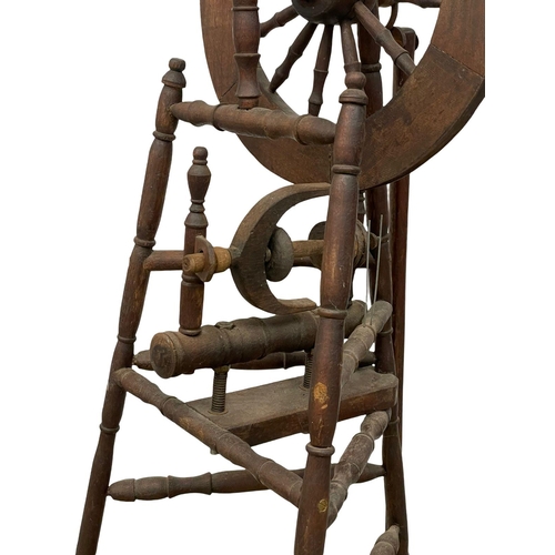 178 - A tall spinning wheel. 127cm