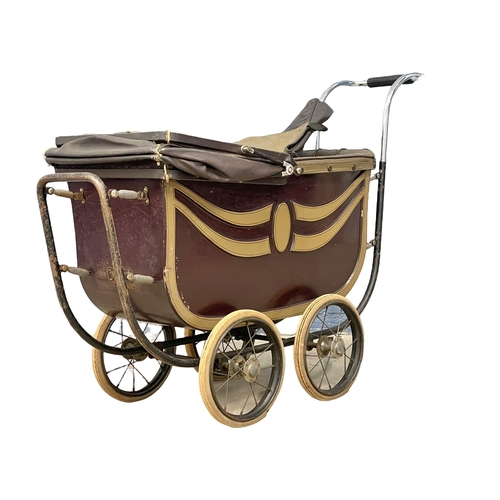 251 - A vintage dolls pram by The Marmet. 103cm