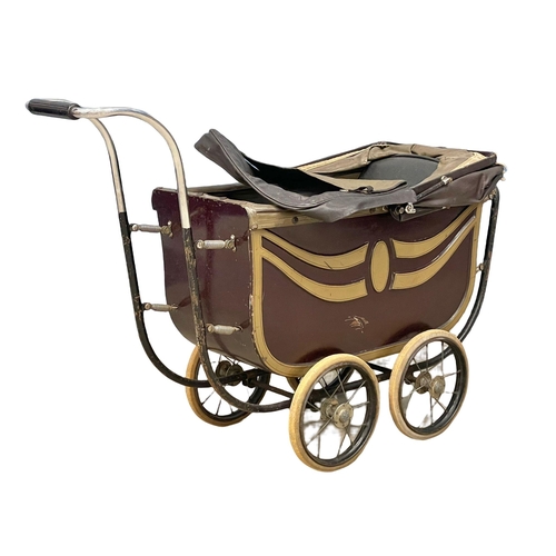 251 - A vintage dolls pram by The Marmet. 103cm