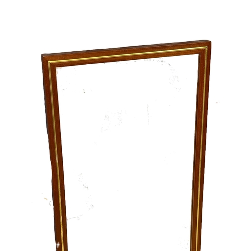 270V - A Mid Century teak and brass framed mirror. 36x75cm