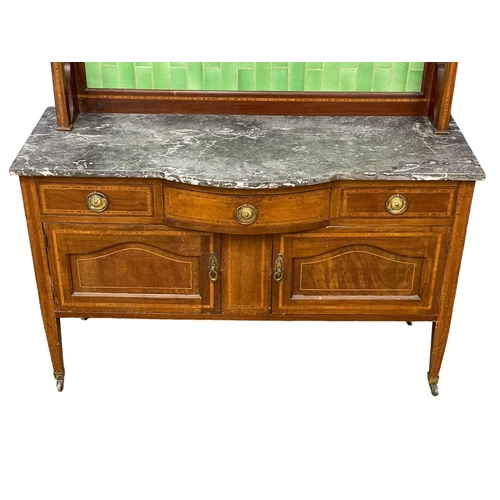 270D - An Edwardian inlaid mahogany marble top washstand with tiled gallery. 125x48x144cm