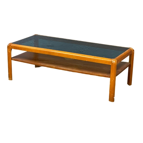 270F - A Nathan Mid Century teak 2 tier coffee table with smoked glass top. 107x49x36cm