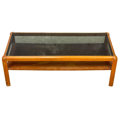 270F - A Nathan Mid Century teak 2 tier coffee table with smoked glass top. 107x49x36cm