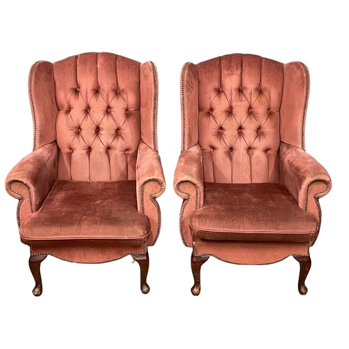 281M - A pair of deep button wingback armchairs.