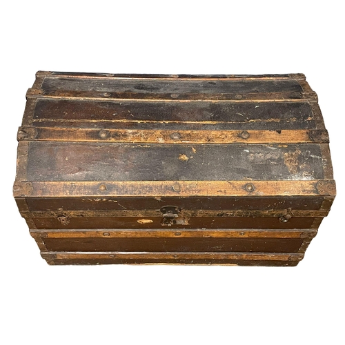 281H - An early 20th century dome top trunk. 85x49x52cm