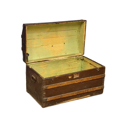 281H - An early 20th century dome top trunk. 85x49x52cm