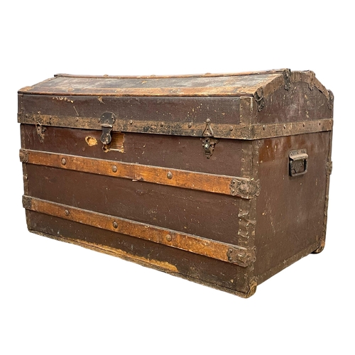 281H - An early 20th century dome top trunk. 85x49x52cm