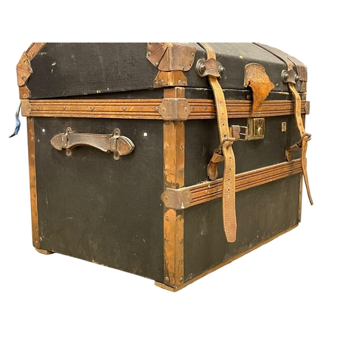 281K - An early 20th century dome top leather and wooden trunk. Circa 1900-1920. 70x49x59cm