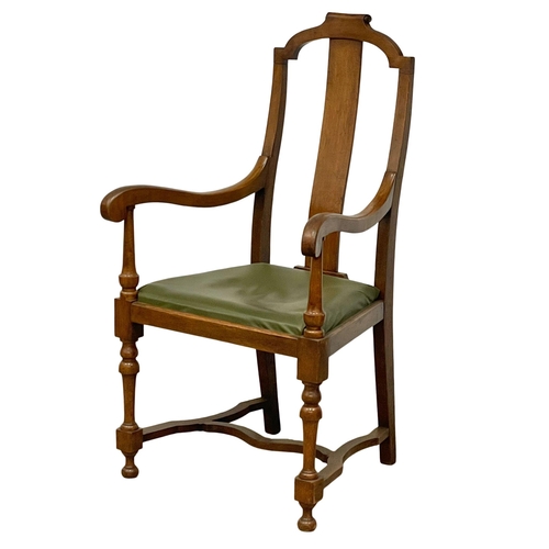 374B - A large early 20th century oak and beech armchair with leather seat. Circa 1920.