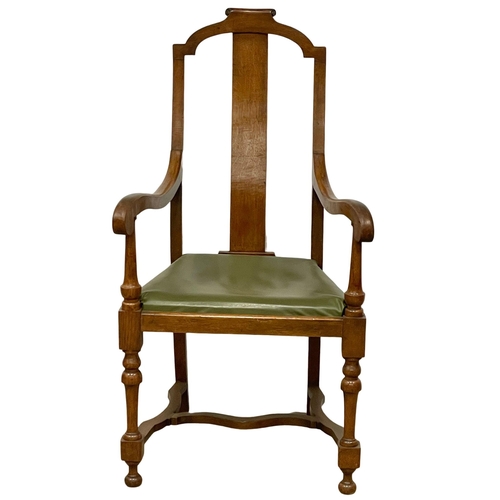 374B - A large early 20th century oak and beech armchair with leather seat. Circa 1920.