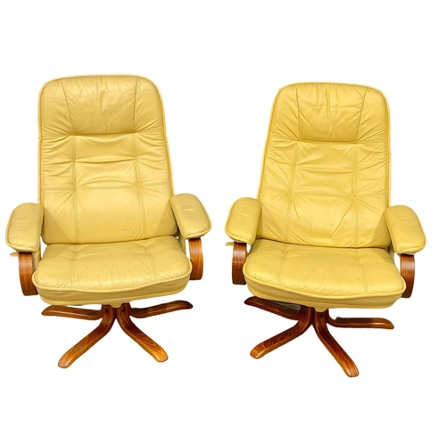 374D - A pair of leather armchairs with matching stools.