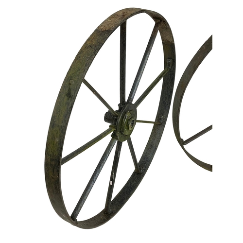 61 - A pair of large 19th century steel wagon wheels. 112cm