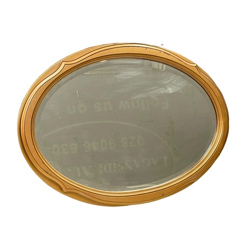 749 - An oval gilt framed bevelled mirror 86x62cm