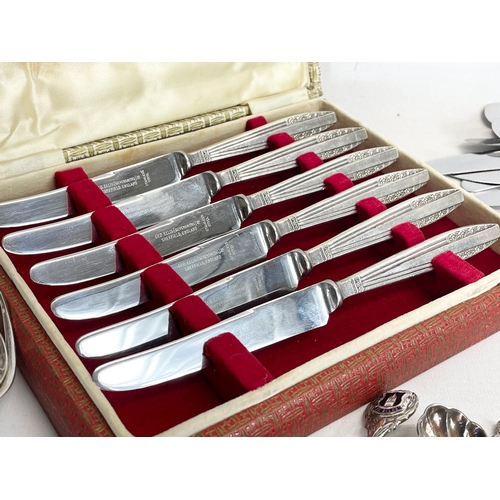 776 - A quantity of silver plated cutlery and a 3 piece vintage brass vanity set.