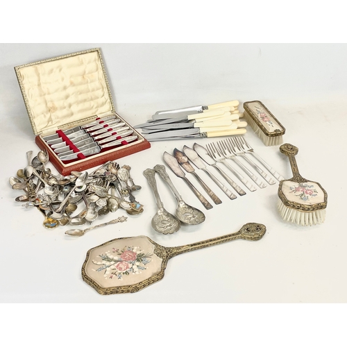 776 - A quantity of silver plated cutlery and a 3 piece vintage brass vanity set.