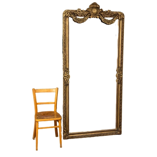 949 - A very large ornate gilt framed bevelled mirror. 99.5x212cm