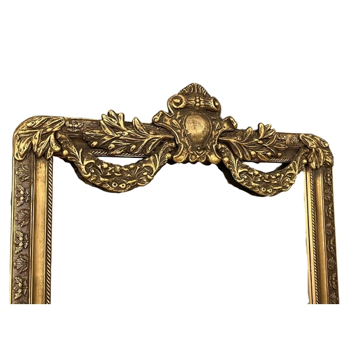 949 - A very large ornate gilt framed bevelled mirror. 99.5x212cm