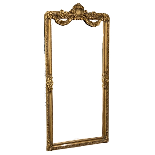 949 - A very large ornate gilt framed bevelled mirror. 99.5x212cm