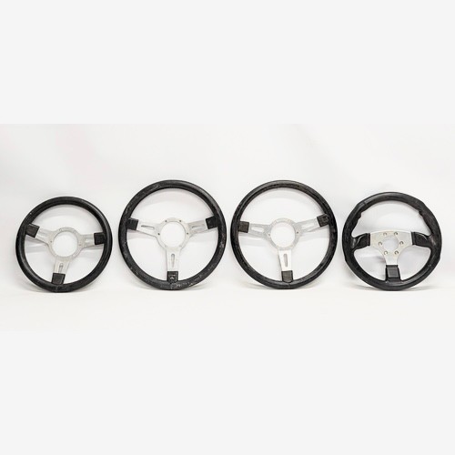 260E - 4 vintage race car steering wheels.