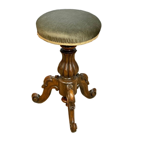 1108 - A Victorian carved Rosewood telescopic piano stool.