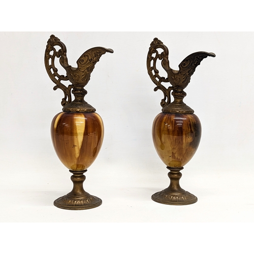 400 - A pair of ornate early 20th century brass and onyx ornamental ewers. 28cm