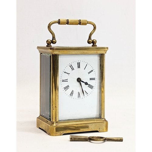 137 - A late 19th century brass carriage clock with key.