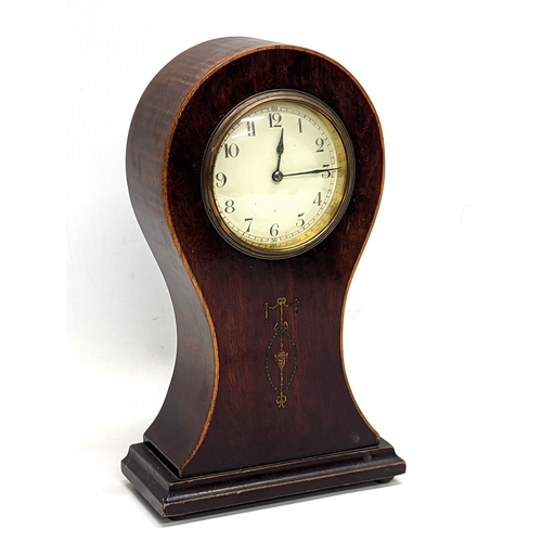 139 - An Edwardian inlaid mahogany balloon mantle clock with key. 28cm