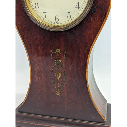 139 - An Edwardian inlaid mahogany balloon mantle clock with key. 28cm