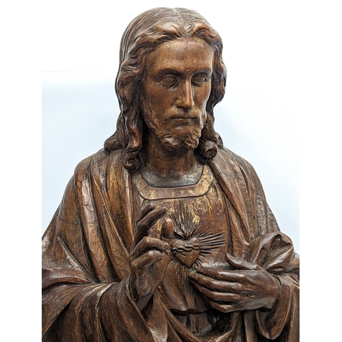 140 - A large 19th century carved limewood figure of Jesus Christ, with polychrome finish. 110cm