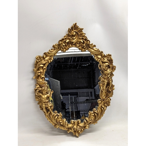 157 - An ornate gilt framed mirror. 47x68.5cm
