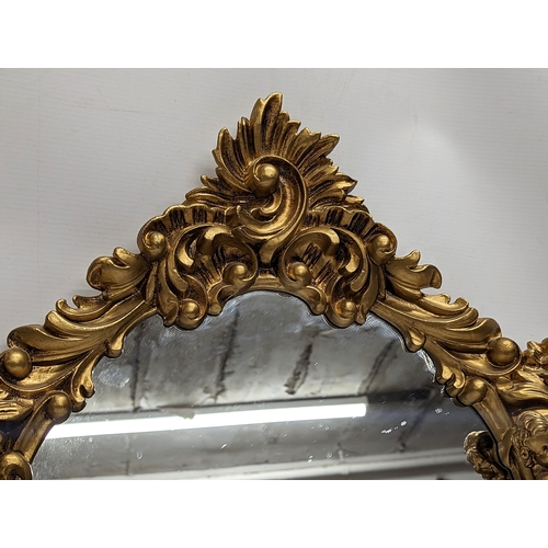 157 - An ornate gilt framed mirror. 47x68.5cm