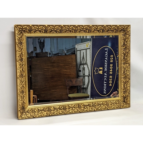 161 - A bevelled gilt framed mirror. 86.5x63.5cm