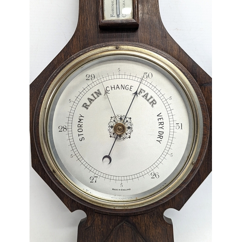 196 - An early 20th century oak barometer. 62x22cm