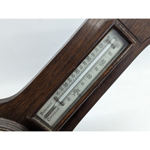 196 - An early 20th century oak barometer. 62x22cm