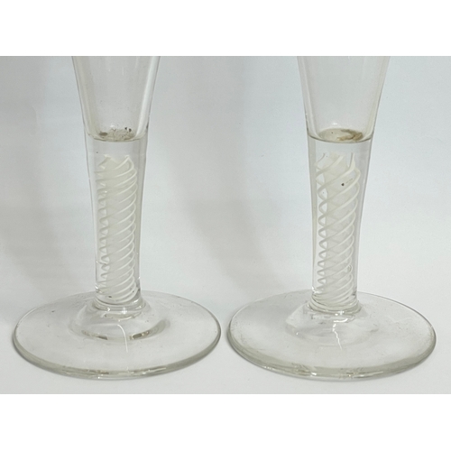 428 - A pair of 18th century George III glass twist stem champagne flute glasses. Circa 1760. 17.5cm