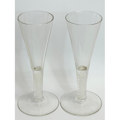 428 - A pair of 18th century George III glass twist stem champagne flute glasses. Circa 1760. 17.5cm