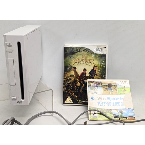 327 - A Nintendo Wii game console with cables/leads and remotes, 2 games (The Spiderwick Chronicles, and W... 