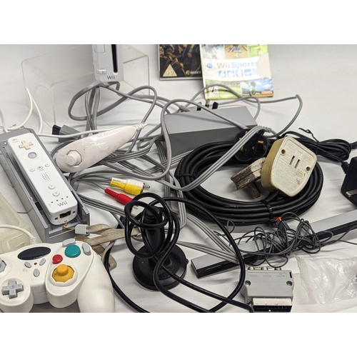 327 - A Nintendo Wii game console with cables/leads and remotes, 2 games (The Spiderwick Chronicles, and W... 