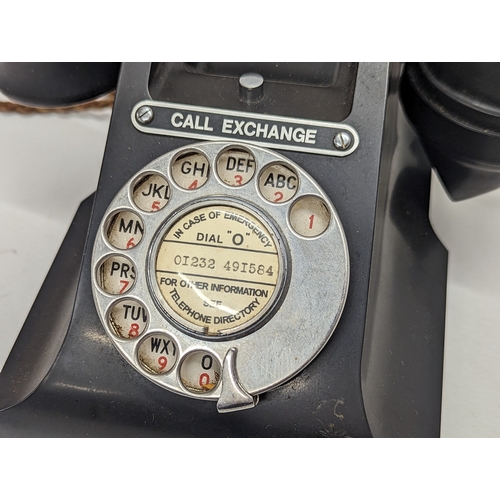 223 - A vintage Bakelite telephone, stamped GPO.