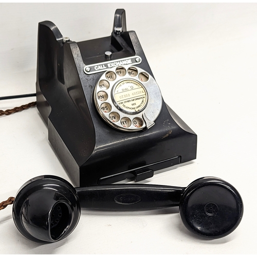 223 - A vintage Bakelite telephone, stamped GPO.