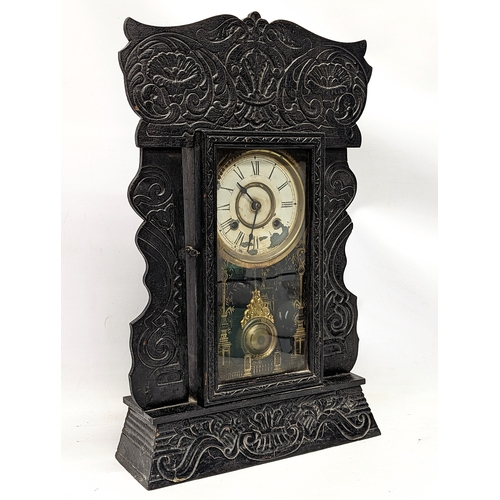 170 - A late 19th century ornate gingerbread mantle clock, with pendulum and key. 36.5x58.5cm