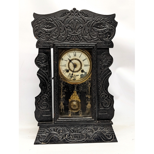 170 - A late 19th century ornate gingerbread mantle clock, with pendulum and key. 36.5x58.5cm
