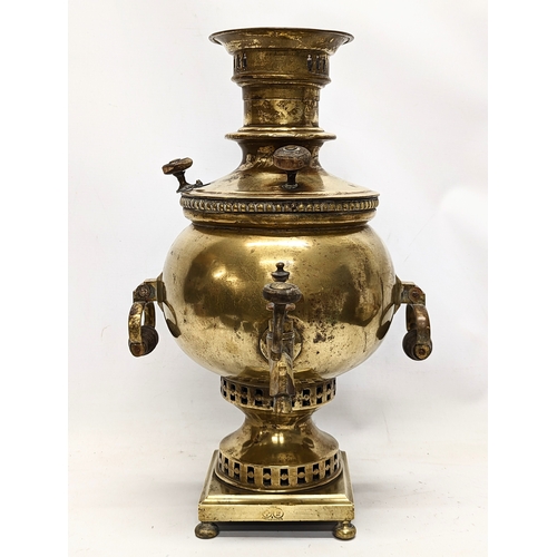 265 - A late 19th / early 20th century ornate brass samovar, stamped. 45cm