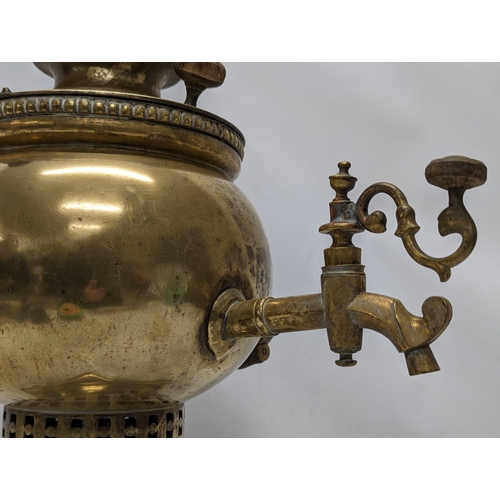 265 - A late 19th / early 20th century ornate brass samovar, stamped. 45cm