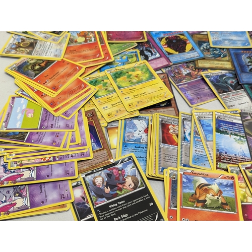 332 - A collection of Pokémon and Yu-Gi-Oh! game cards, in Pokémon tin.