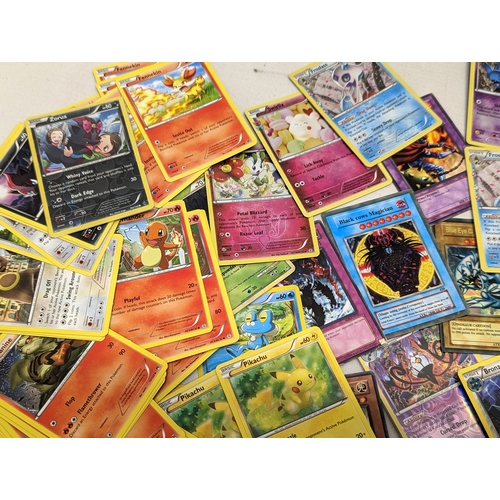 332 - A collection of Pokémon and Yu-Gi-Oh! game cards, in Pokémon tin.